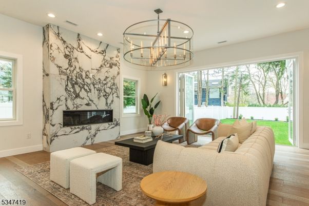 Chandelier, Fireplace, Interior, Living room, Marble Walls, Recessed Lighting, Wood Texture Flooring