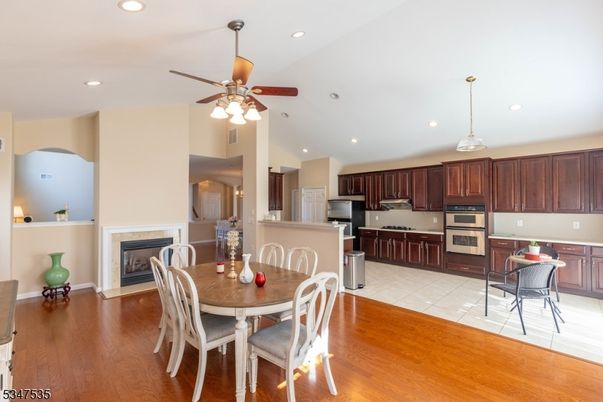 Dining room, Fireplace, Interior, Kitchen, Pendant Lights, Recessed Lighting, Stainless Steel Appliances, Wood Texture Flooring