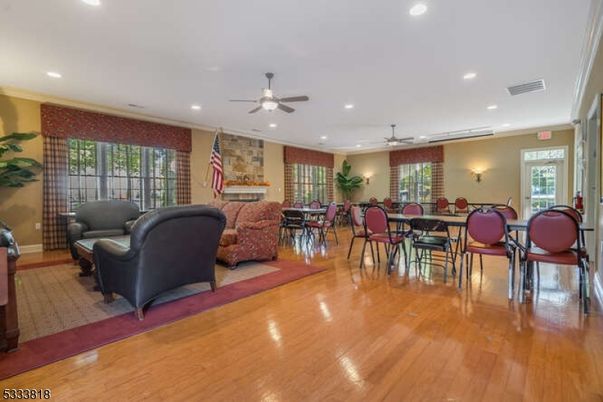 Dining room, Fireplace, Interior, Living room, Recessed Lighting, Stone Walls, Wood Texture Flooring