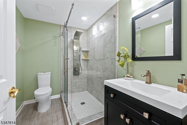 Bathroom, Glass Shower, Interior, Marble Walls, Recessed Lighting, Wood Texture Flooring