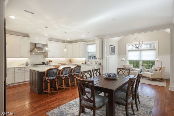 Chandelier, Dining room, Interior, Kitchen, Living room, Pendant Lights, Recessed Lighting, Stainless Steel Appliances, Wood Texture Flooring