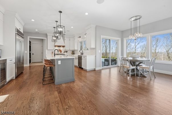 Dining room, Interior, Kitchen, Pendant Lights, Recessed Lighting, Stainless Steel Appliances, Wood Texture Flooring