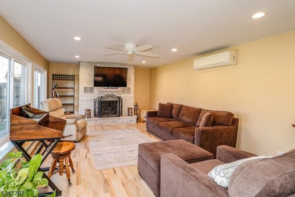 Fireplace, Interior, Living room, Recessed Lighting, Stone Walls, Wood Texture Flooring