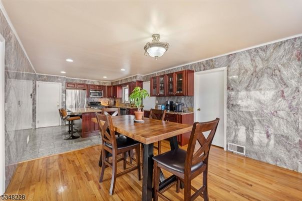 Dining room, Interior, Kitchen, Marble, Marble Walls, Recessed Lighting, Stainless Steel Appliances, Wood Texture Flooring