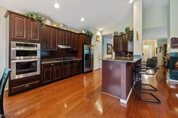 Fireplace, Interior, Kitchen, Recessed Lighting, Stainless Steel Appliances, Wood Texture Flooring