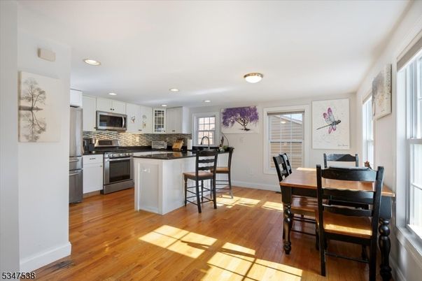 Dining room, Interior, Kitchen, Recessed Lighting, Stainless Steel Appliances, Wood Texture Flooring