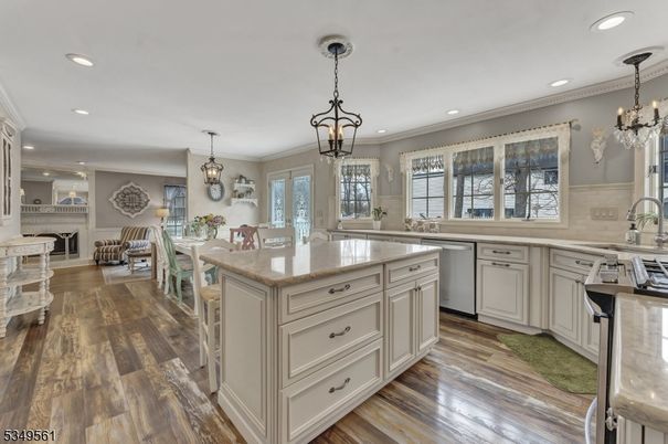 Chandelier, Dining room, Fireplace, Interior, Kitchen, Living room, Pendant Lights, Recessed Lighting, Stainless Steel Appliances, Wood Texture Flooring
