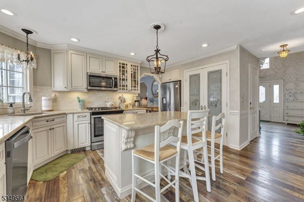 Chandelier, Interior, Kitchen, Pendant Lights, Recessed Lighting, Stainless Steel Appliances, Wood Texture Flooring