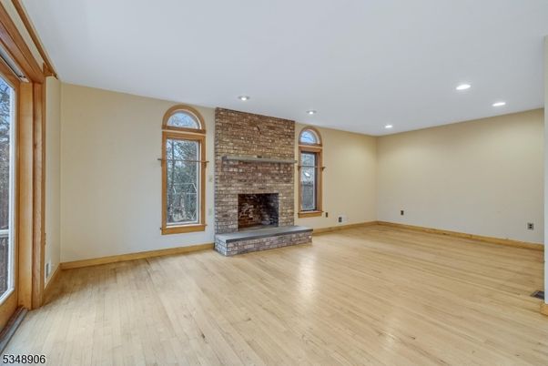 Empty room, Fireplace, Interior, Recessed Lighting, Stone Walls, Wood Texture Flooring