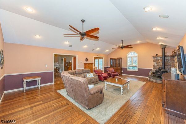 Fireplace, Interior, Living room, Recessed Lighting, Stone Walls, Wood Texture Flooring