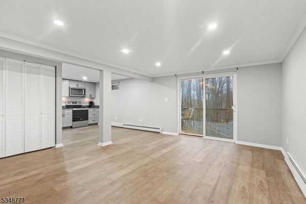 Empty room, Interior, Kitchen, Recessed Lighting, Stainless Steel Appliances, Wood Texture Flooring