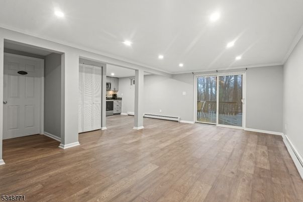 Empty room, Interior, Kitchen, Recessed Lighting, Stainless Steel Appliances, Wood Texture Flooring