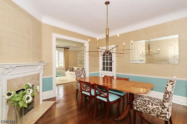 Chandelier, Dining room, Fireplace, Interior, Living room, Pendant Lights, Recessed Lighting, Wood Texture Flooring
