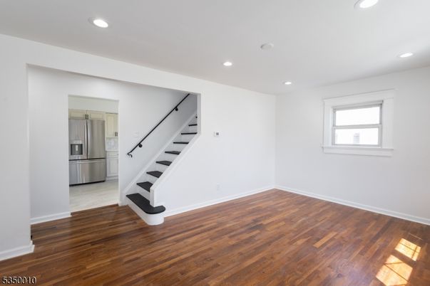 Empty room, Interior, Kitchen, Recessed Lighting, Stainless Steel Appliances, Wood Texture Flooring