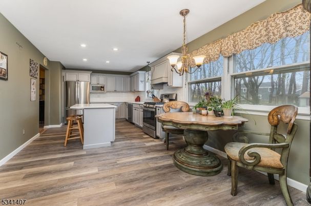 Chandelier, Dining room, Interior, Kitchen, Pendant Lights, Recessed Lighting, Stainless Steel Appliances, Wood Texture Flooring