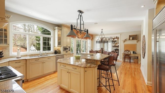 Chandelier, Dining room, Fireplace, Interior, Kitchen, Pendant Lights, Recessed Lighting, Stainless Steel Appliances, Wood Texture Flooring