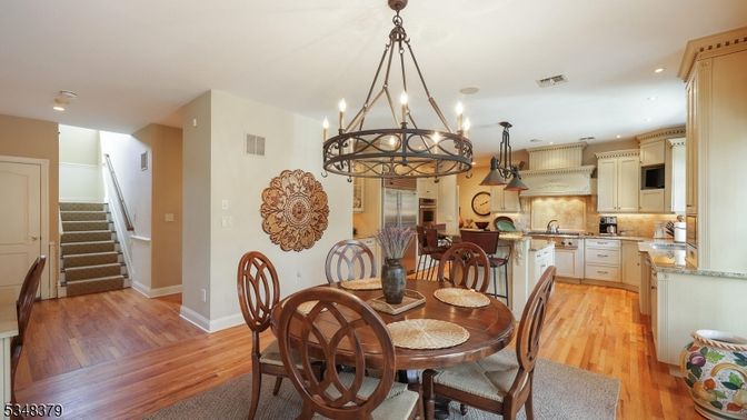 Chandelier, Dining room, Interior, Kitchen, Pendant Lights, Recessed Lighting, Stainless Steel Appliances, Wood Texture Flooring