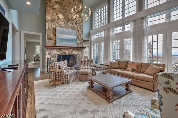 Chandelier, Fireplace, Interior, Living room, Recessed Lighting, Stone Walls, Wood Texture Flooring