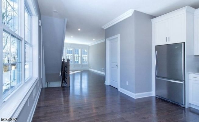 Empty room, Interior, Kitchen, Recessed Lighting, Stainless Steel Appliances, Wood Texture Flooring