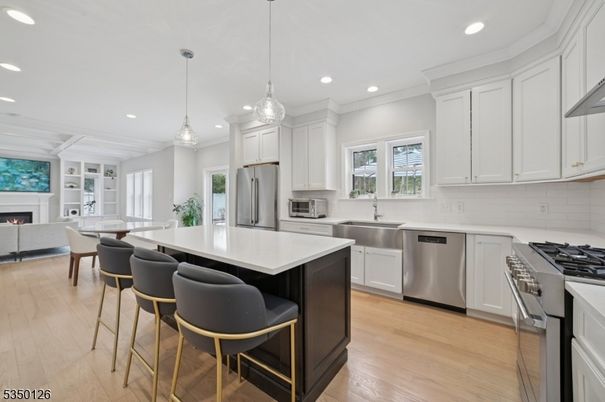 Fireplace, Interior, Kitchen, Pendant Lights, Recessed Lighting, Stainless Steel Appliances, Wood Texture Flooring
