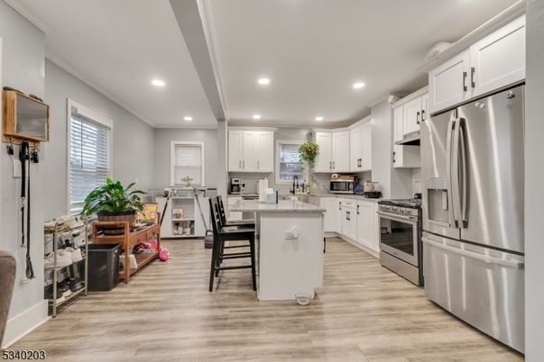 Dining room, Interior, Kitchen, Recessed Lighting, Stainless Steel Appliances, Wood Texture Flooring