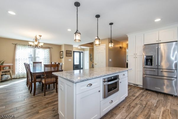 Chandelier, Dining room, Interior, Kitchen, Pendant Lights, Recessed Lighting, Stainless Steel Appliances, Wood Texture Flooring