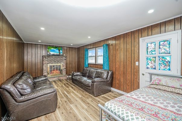 Bedroom, Fireplace, Interior, Living room, Recessed Lighting, Wood Texture Flooring, Wooden Walls