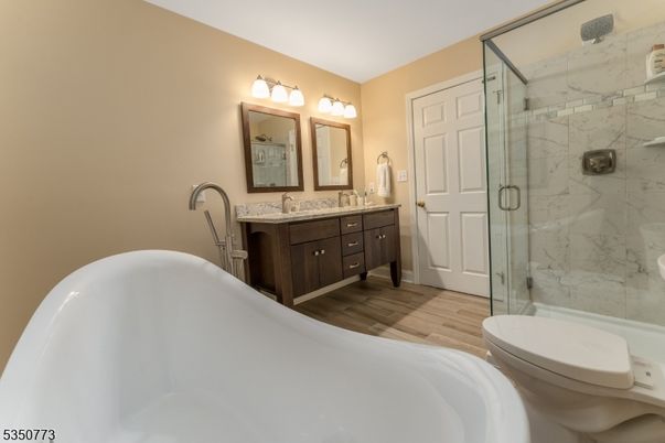 Bathroom, Dual Sink Vanities, Free Standing Baths, Glass Shower, Interior, Marble Walls, Wood Texture Flooring