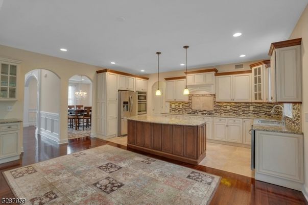 Chandelier, Dining room, Interior, Kitchen, Pendant Lights, Recessed Lighting, Stainless Steel Appliances, Wood Texture Flooring