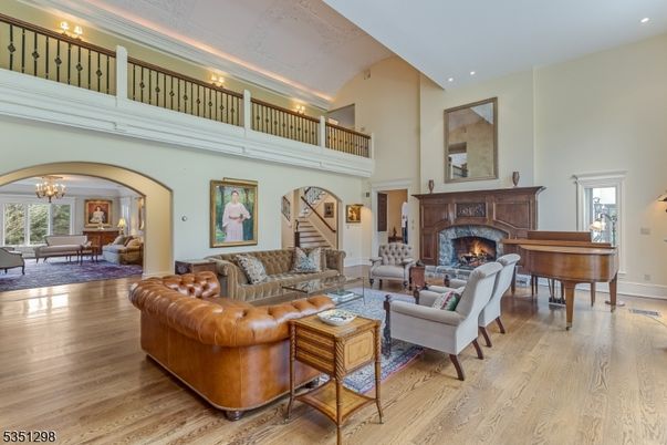 Chandelier, Fireplace, Interior, Living room, Piano, Recessed Lighting, Wood Texture Flooring