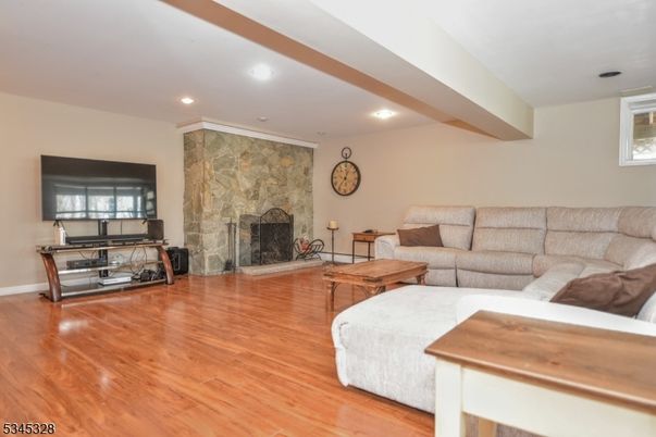 Fireplace, Interior, Living room, Recessed Lighting, Stone Walls, Wood Texture Flooring