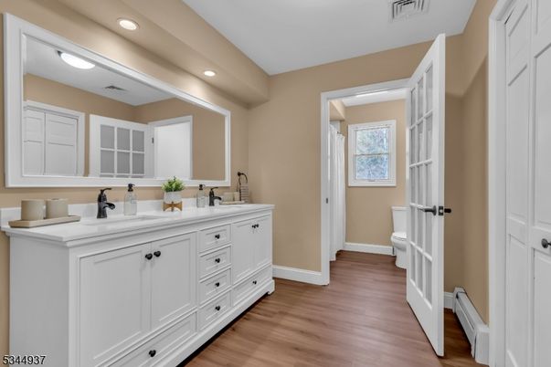 Bathroom, Dual Sink Vanities, Interior, Recessed Lighting, Wood Texture Flooring