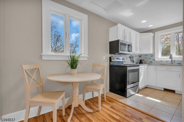 Dining room, Interior, Kitchen, Recessed Lighting, Stainless Steel Appliances, Wood Texture Flooring