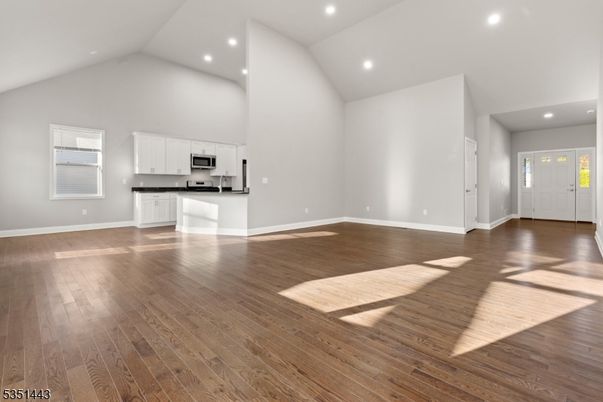 Empty room, Interior, Kitchen, Recessed Lighting, Stainless Steel Appliances, Wood Texture Flooring
