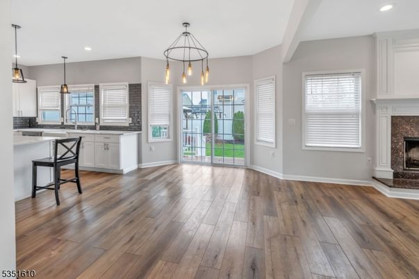 Empty room, Fireplace, Interior, Kitchen, Pendant Lights, Recessed Lighting, Wood Texture Flooring