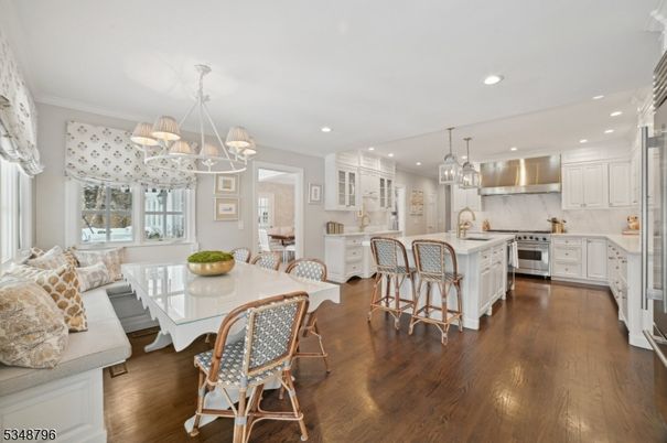 Chandelier, Dining room, Interior, Kitchen, Living room, Pendant Lights, Recessed Lighting, Stainless Steel Appliances, Wood Texture Flooring
