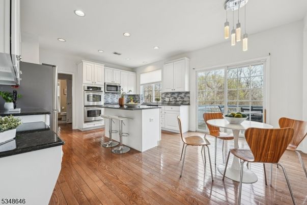 Dining room, Interior, Kitchen, Pendant Lights, Recessed Lighting, Stainless Steel Appliances, Wood Texture Flooring