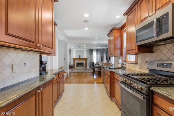 Dining room, Fireplace, Interior, Kitchen, Living room, Recessed Lighting, Stainless Steel Appliances, Wood Texture Flooring