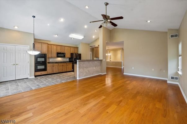 Empty room, Interior, Kitchen, Pendant Lights, Recessed Lighting, Stainless Steel Appliances, Wood Texture Flooring