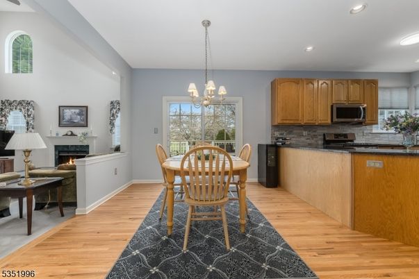 Chandelier, Dining room, Fireplace, Interior, Kitchen, Pendant Lights, Recessed Lighting, Wood Texture Flooring
