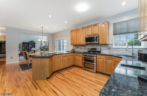 Chandelier, Dining room, Interior, Kitchen, Recessed Lighting, Stainless Steel Appliances, Wood Texture Flooring