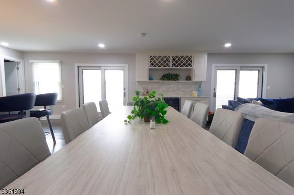 Dining room, Fireplace, Interior, Living room, Recessed Lighting, Wood Texture Flooring