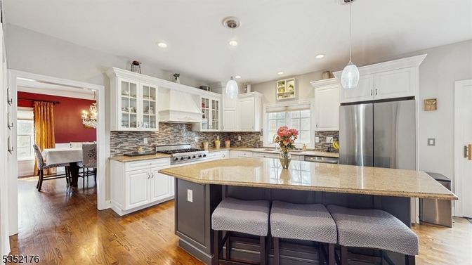Chandelier, Dining room, Interior, Kitchen, Pendant Lights, Recessed Lighting, Stainless Steel Appliances, Wood Texture Flooring