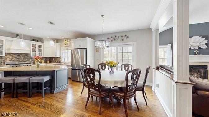 Chandelier, Dining room, Fireplace, Interior, Kitchen, Pendant Lights, Recessed Lighting, Stainless Steel Appliances, Wood Texture Flooring