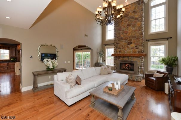 Chandelier, Fireplace, Interior, Living room, Recessed Lighting, Stone Walls, Wood Texture Flooring