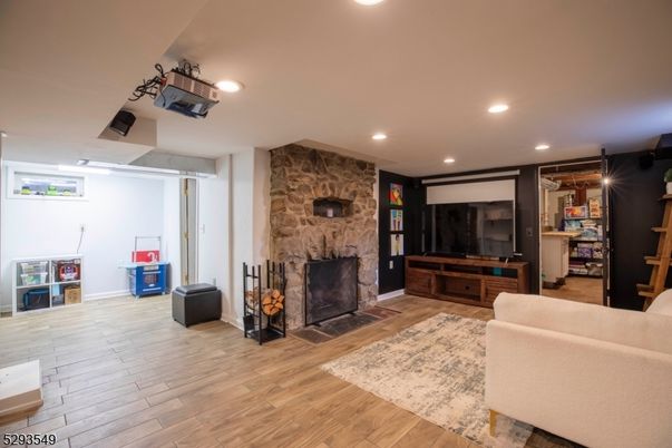 Fireplace, Interior, Living room, Recessed Lighting, Stone Walls, Wood Texture Flooring
