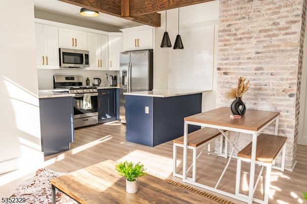 Interior, Kitchen, Pendant Lights, Recessed Lighting, Stainless Steel Appliances, Stone Walls, Wood Texture Flooring