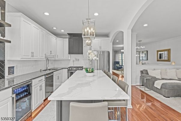 Chandelier, Dining room, Interior, Kitchen, Living room, Pendant Lights, Recessed Lighting, Stainless Steel Appliances, Wood Texture Flooring