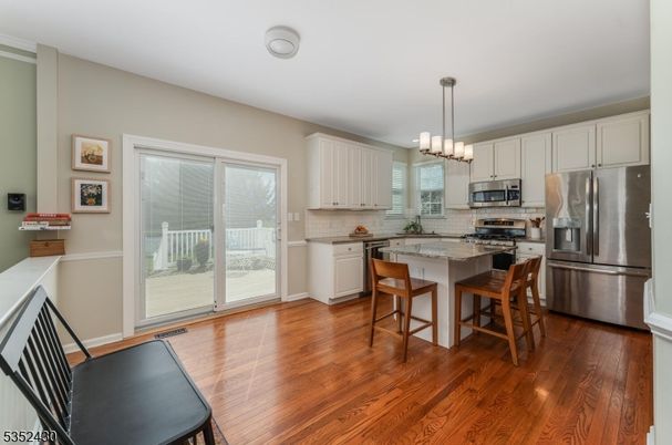 Chandelier, Dining room, Interior, Kitchen, Pendant Lights, Stainless Steel Appliances, Wood Texture Flooring