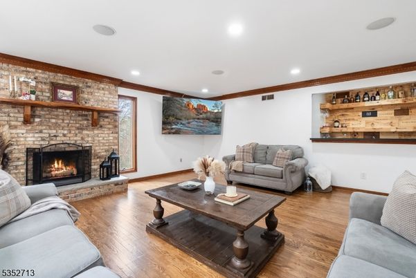 Fireplace, Interior, Living room, Recessed Lighting, Stone Walls, Wood Texture Flooring